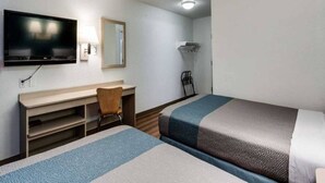 A hotel room with two beds, a desk, a chair, a television, and a mirror. - 2 Full Beds | Smoking, Micfridge (Spokane)
