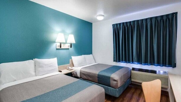 A hotel room with two beds, a desk, and a chair. - 2 Full Beds | Smoking, Micfridge (Spokane)