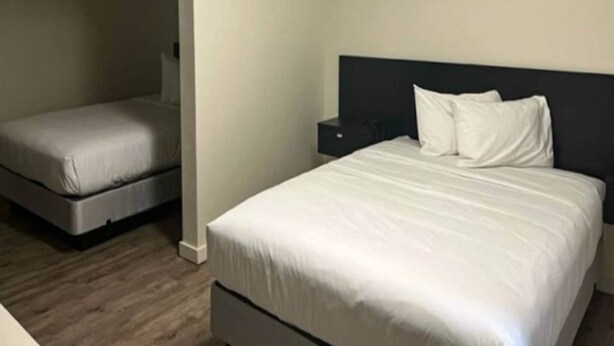 A hotel room with a large bed, a smaller bed, a nightstand, and a wardrobe. - 1 Queen Bed | Mobil Access Tub Nsmk Kitchen (Pasco)