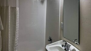 A bathroom with a shower, a sink, and a mirror. - 1 Queen Bed | Mobil Access Tub Nsmk Kitchen (Pasco)