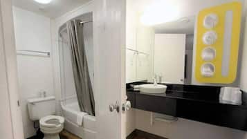 A bathroom with a toilet, bathtub, and sink.