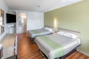 A hotel room with two beds, a desk, a television, and a bathroom. - 2 Queen Beds | Non-Smoking (Clarkston)