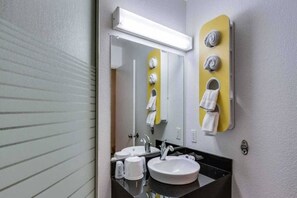 A bathroom with a white sink, a mirror, and a towel rack. - 1 Full Bed | ADA/RI Shower/Smoking (Spokane)