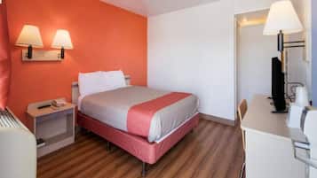 A hotel room with a bed, bedside tables, a desk, and a chair.