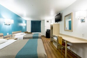 A hotel room with two beds, a desk, a chair, a television, and a window with curtains. - Cozy 2-Bed Queen|Free Parking|Wifi (Roswell)