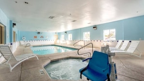 An indoor swimming pool with a hot tub, lounge chairs, and a clear ceiling. - Cozy 2-bed|Free parking (Roswell)