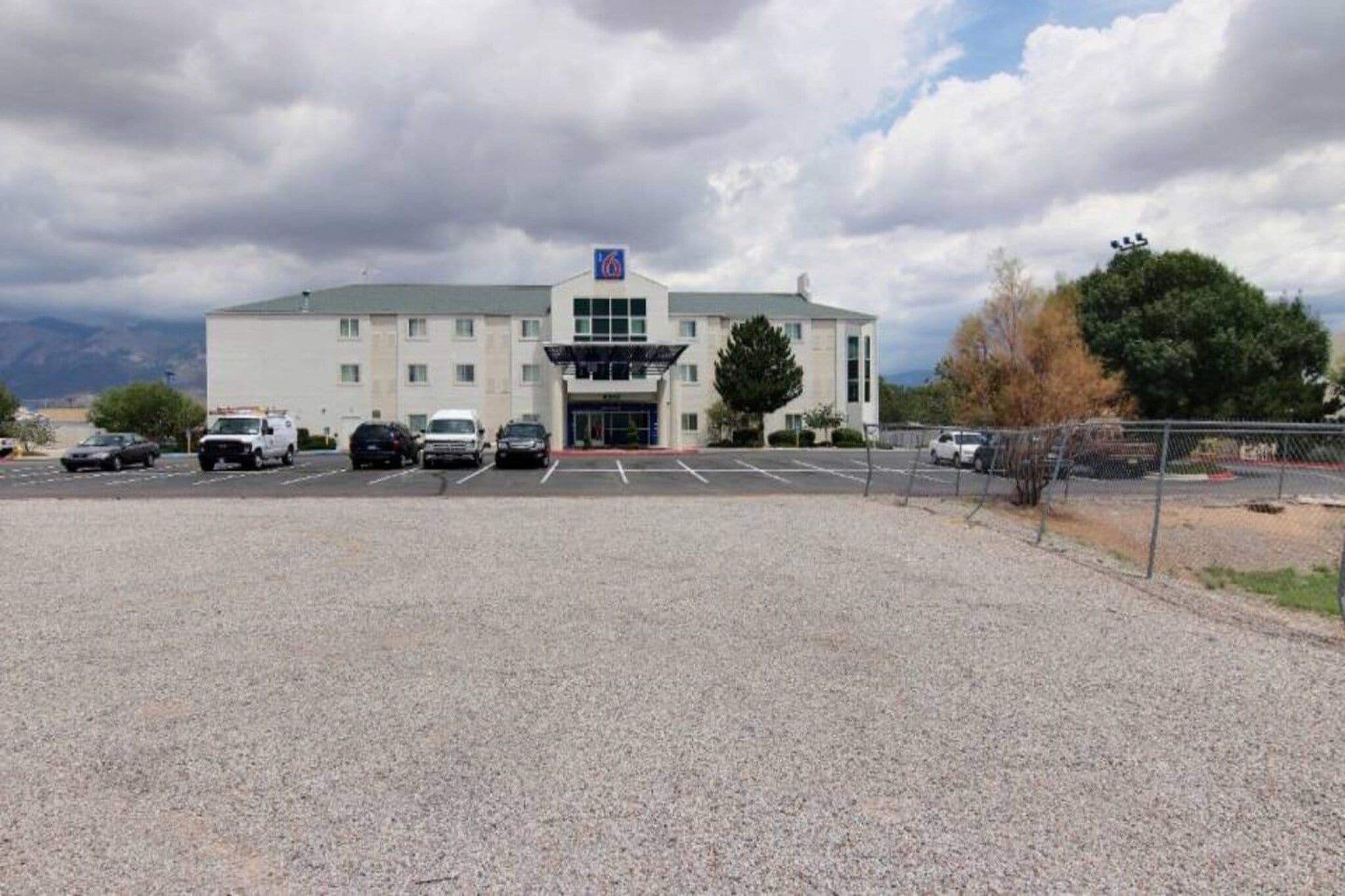 A large building with a parking lot in front.