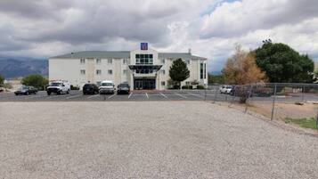 A large building with a parking lot in front.