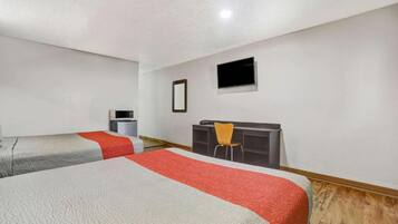 A hotel room with two beds, a desk, a chair, a television, and a microwave.