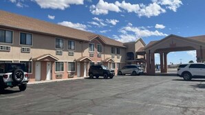 A motel with multiple rooms, a gas station, and a parking lot. - 2 Queen Beds | Non-Smoking, Micfridge (Deming NM)