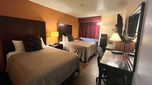 A hotel room with two beds, a desk, a chair, a television, and a window with curtains. - 2 Queen Beds | Non-Smoking, Micfridge (Deming NM)