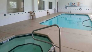 An indoor swimming pool with a tiled floor, a metal pool ladder, and a chair. - 2 Queen Beds|Suite,Nsmk,Kitchen (Las Cruces)