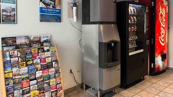 A vending machine, a refrigerator, and a display of travel books.