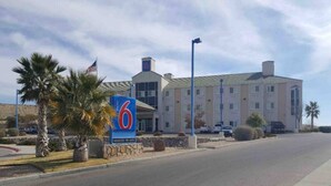 A hotel with a large sign, a parking lot, and a building with multiple windows. - 2 Queen Beds|Suite,Nsmk,Kitchen (Las Cruces)
