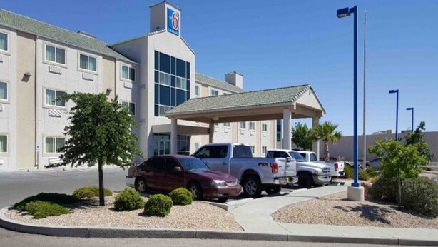 A hotel with a covered entrance, multiple vehicles parked in front, and a clear sky. - 2 Queen Beds|Suite,Nsmk,Kitchen (Las Cruces)