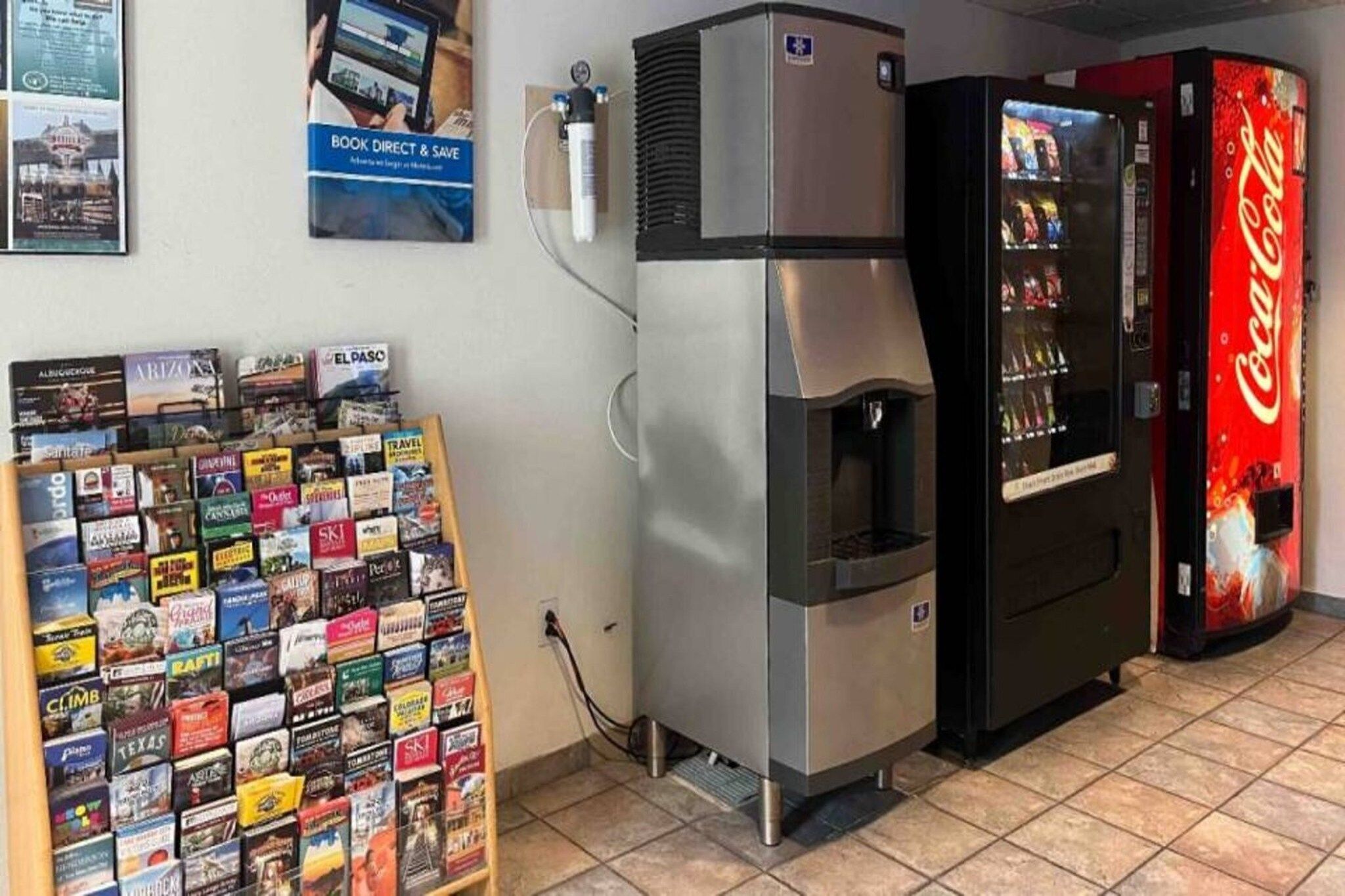 A vending machine, a refrigerator, and a display of travel books.