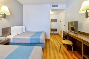 A hotel room with two beds, a desk with a television, and a chair. - Cozy 2-bed Room|Pool|Free Parking (TUCUMCARI)