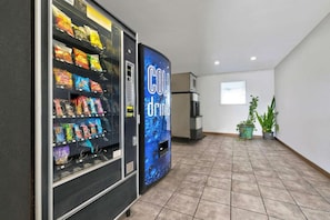 A vending machine area with snacks and a cold drink machine.
