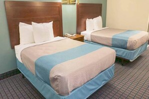 A hotel room with two beds, each with a headboard, bedside tables, and a telephone. - 2 Full Beds | Mobility Accessible Tub Nsmk (MCGRAW)