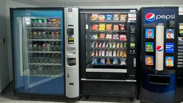 A vending machine area with a Pepsi machine and a refrigerated beverage dispenser.