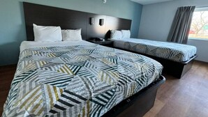 A hotel room with a large bed, a smaller bed, and a nightstand with a lamp. - 2 Queen Beds|Mobility|Tub|Nsmk (East Syracuse)