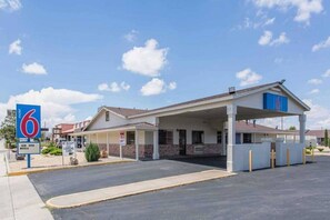A 6 Motel with a covered parking area and a single-story building.