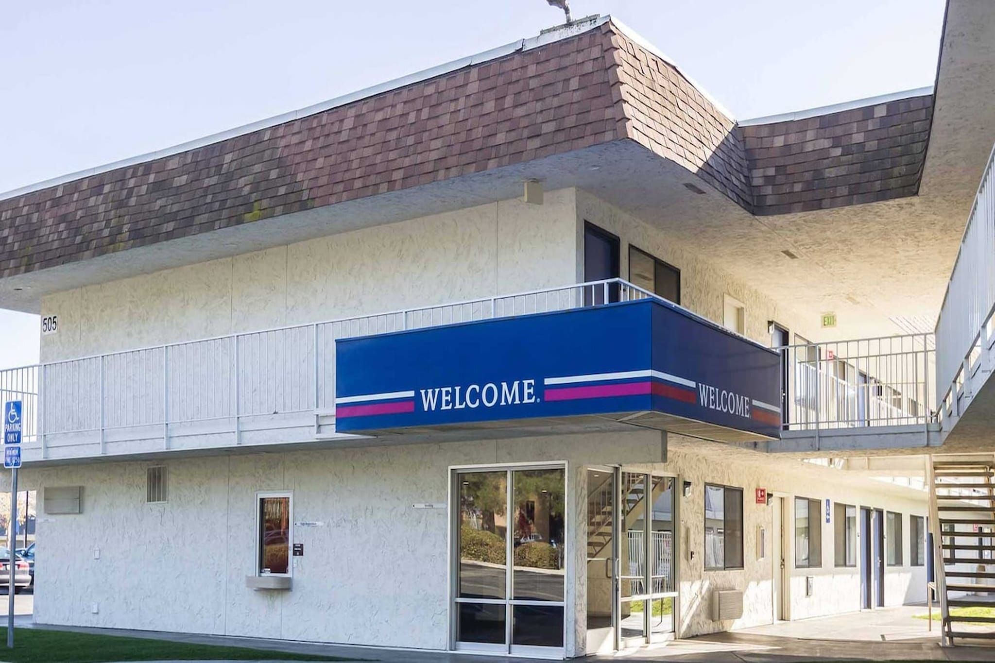 Un edificio de dos pisos con un letrero que dice 'WELCOME'.