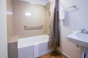 A bathroom with a bathtub, a shower, a sink, and a towel rack. - 1 King Bed|Mobility|Tub, Nsmk (Bremerton)