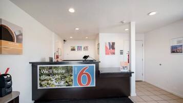A hotel reception desk with a sign indicating the number 6.
