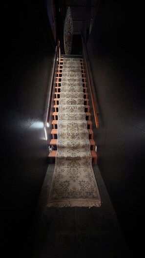 A carpeted staircase with wooden handrails. - Cozy 1-master bedroom in adorable Downtown, Los Angeles with AC , gym, parking (Los Angeles)