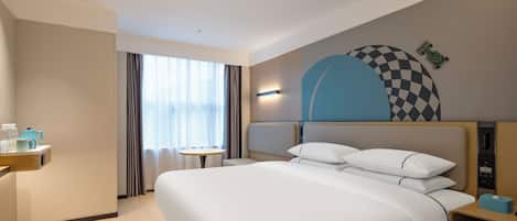 A hotel room with a large bed, bedside tables, a small table, and a window with curtains.