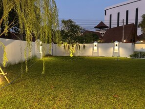 A well-maintained grassy area with a white fence and decorative lights. - Pratumnak 6 Pool Villa Pattaya (Pattaya City)