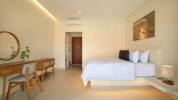 A bedroom with a bed, bedside table, lamp, and a painting on the wall.