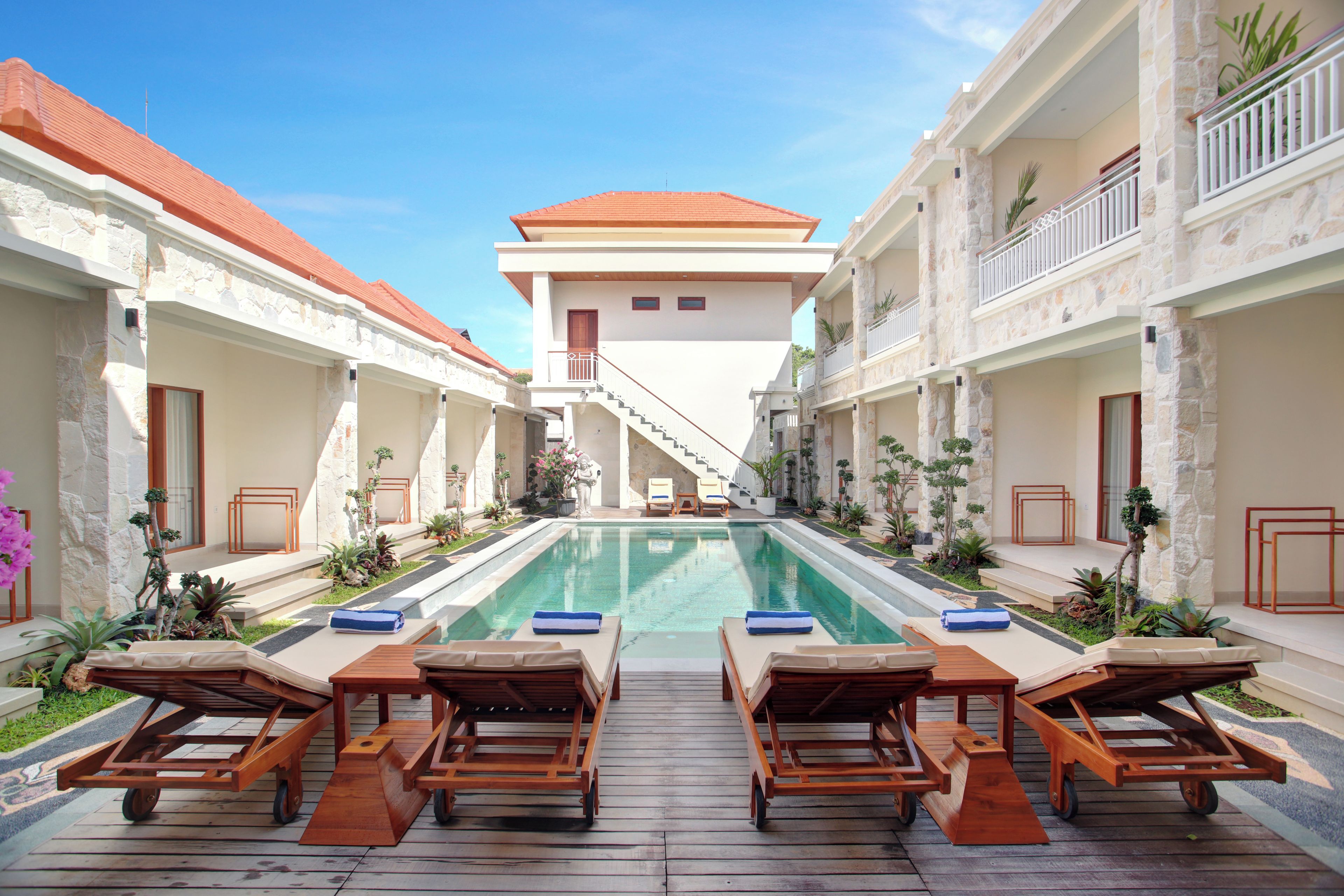 A poolside area with lounge chairs and a clear view of the pool.