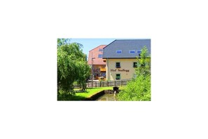 A building with a sign 'Hof Stallegg' and a small water feature in front. - Holiday home Lotus Hof Stallegg (Löffingen)
