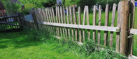 A wooden fence with a satellite dish attached to it.