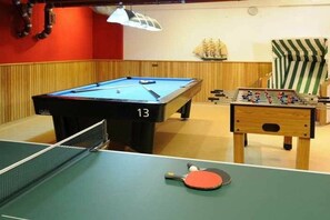 A billiards table with a number 13, a foosball table, and a ping pong table. - Holiday apartment 2 “Dörchläuchting” (Kühlungsborn)