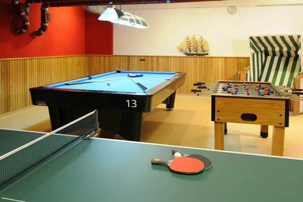 A billiards table with a number 13, a foosball table, and a ping pong table. - Holiday apartment with 2 bedrooms (Kühlungsborn)