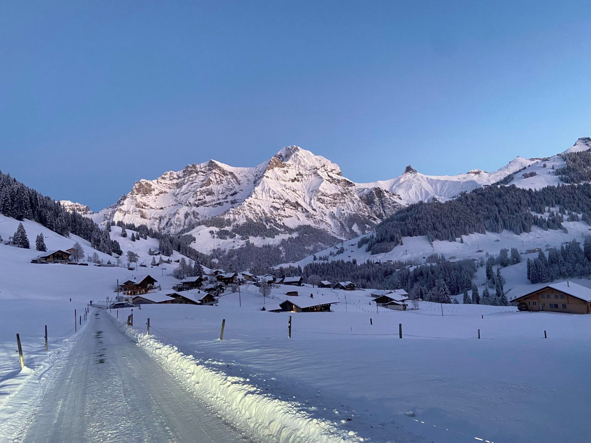 A snow-covered mountain landscape with a clear sky.