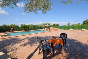 A swimming pool with a patio area, outdoor seating, and a fence. - Cabin in Muro with swimming pool (Muro)