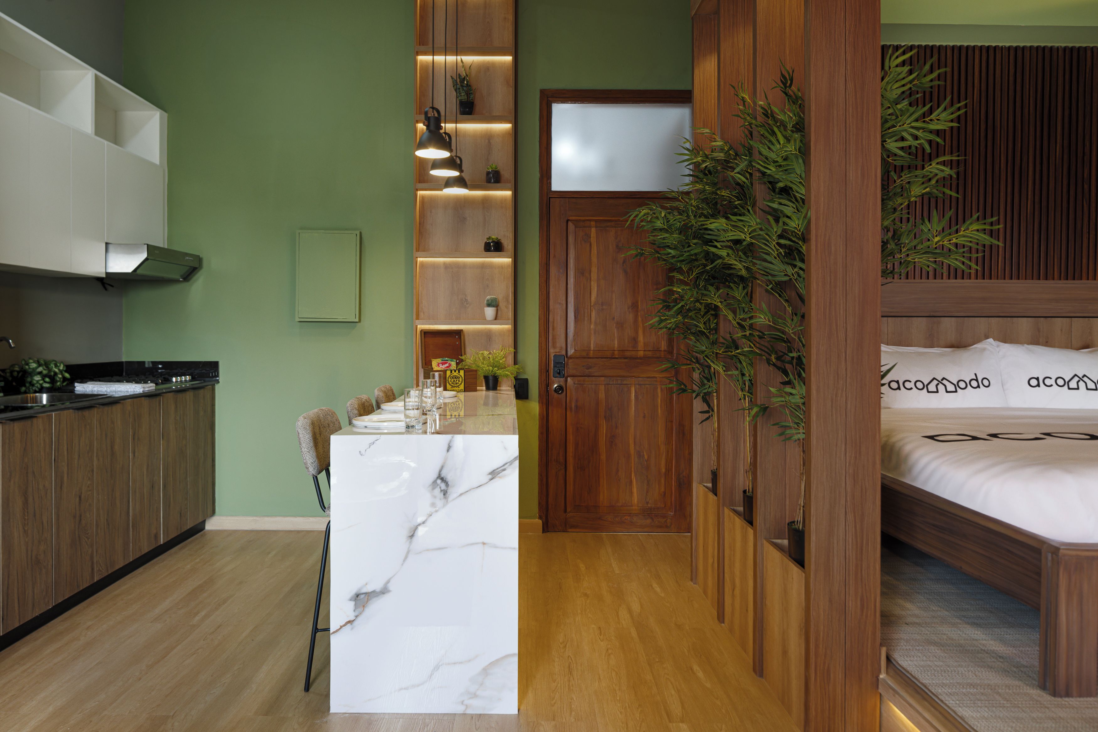 A modern interior with a kitchen, dining area, and a bedroom.