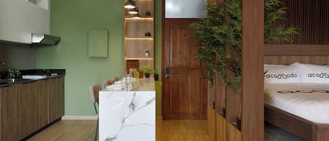 A modern interior with a kitchen, dining area, and a bedroom.