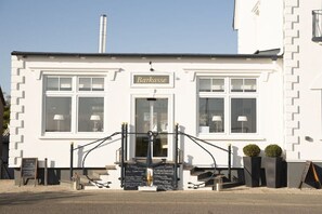A white building with a sign reading 'Barkasse' above the entrance. - Holiday apartment with 1 bedroom (Schönberg)