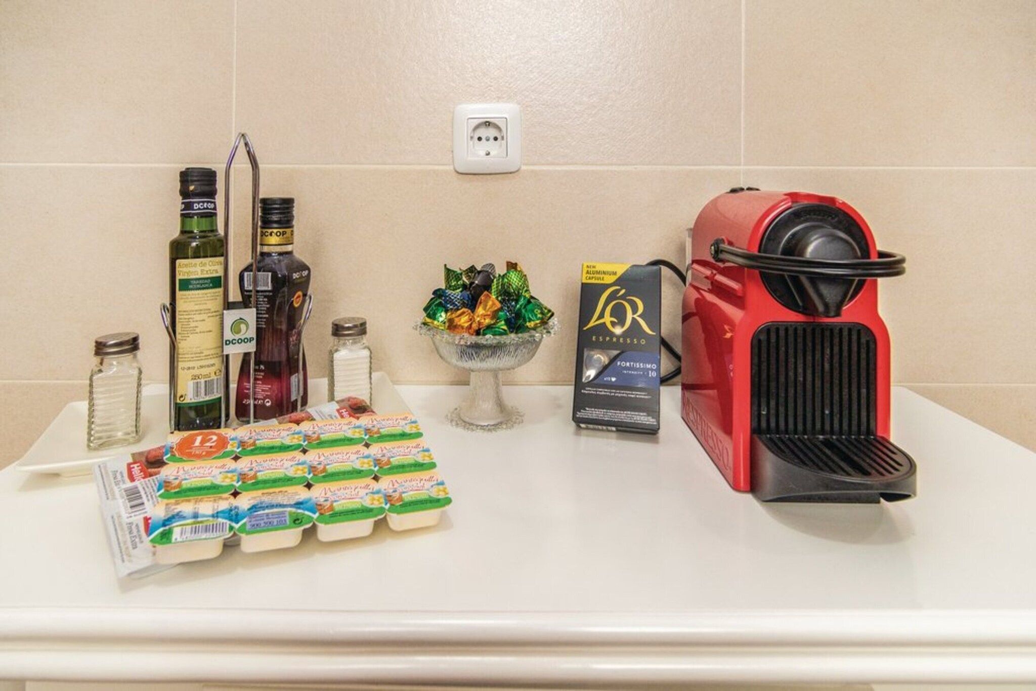 A kitchen counter with a coffee machine, condiments, and packaged goods.