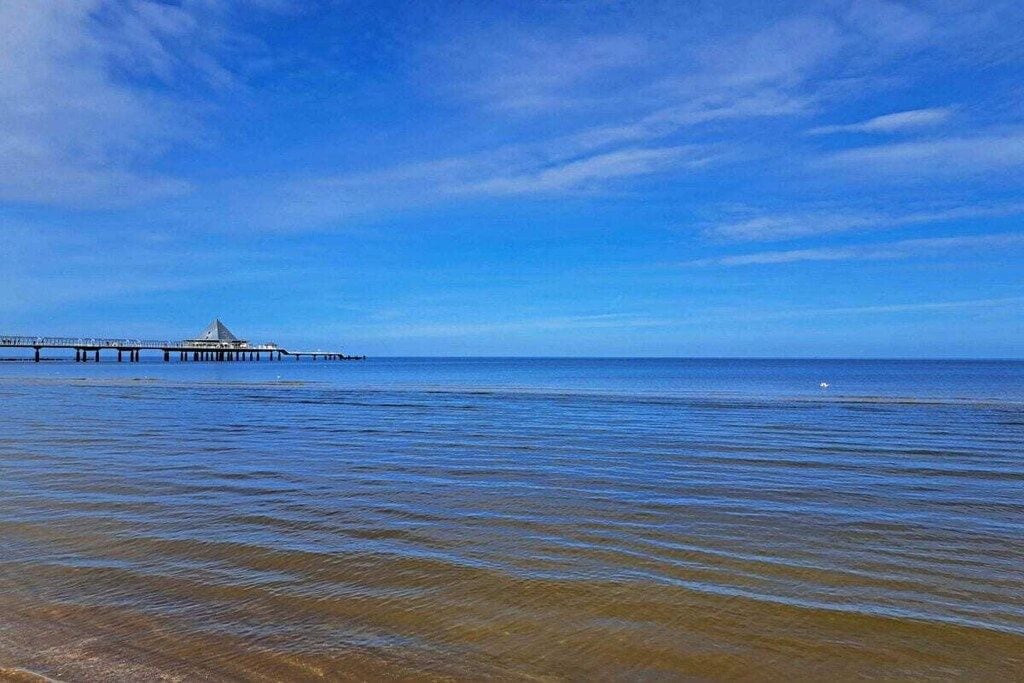 A coastal scene with a pier extending into the water.