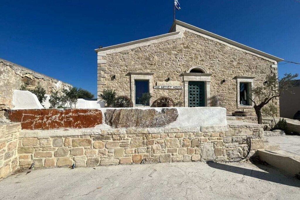 A stone building with a sign reading 'The Artist House.'