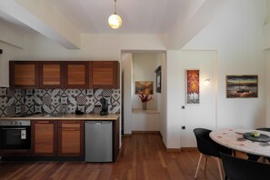 A modern kitchen with wooden cabinets, a built-in dishwasher, and a coffee machine.