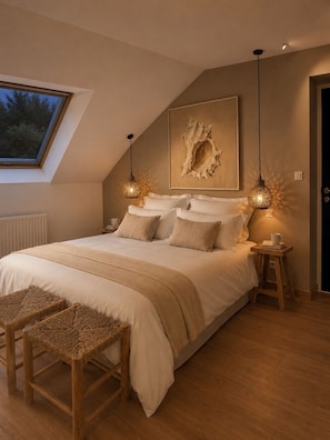 A bedroom with a large bed, two bedside tables, a window, and a ceiling light fixture.