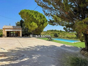A residential property with a swimming pool, outdoor seating, and a patio area. - Masía among vineyards with pool in Catalonia (El Pla de Manlleu)
