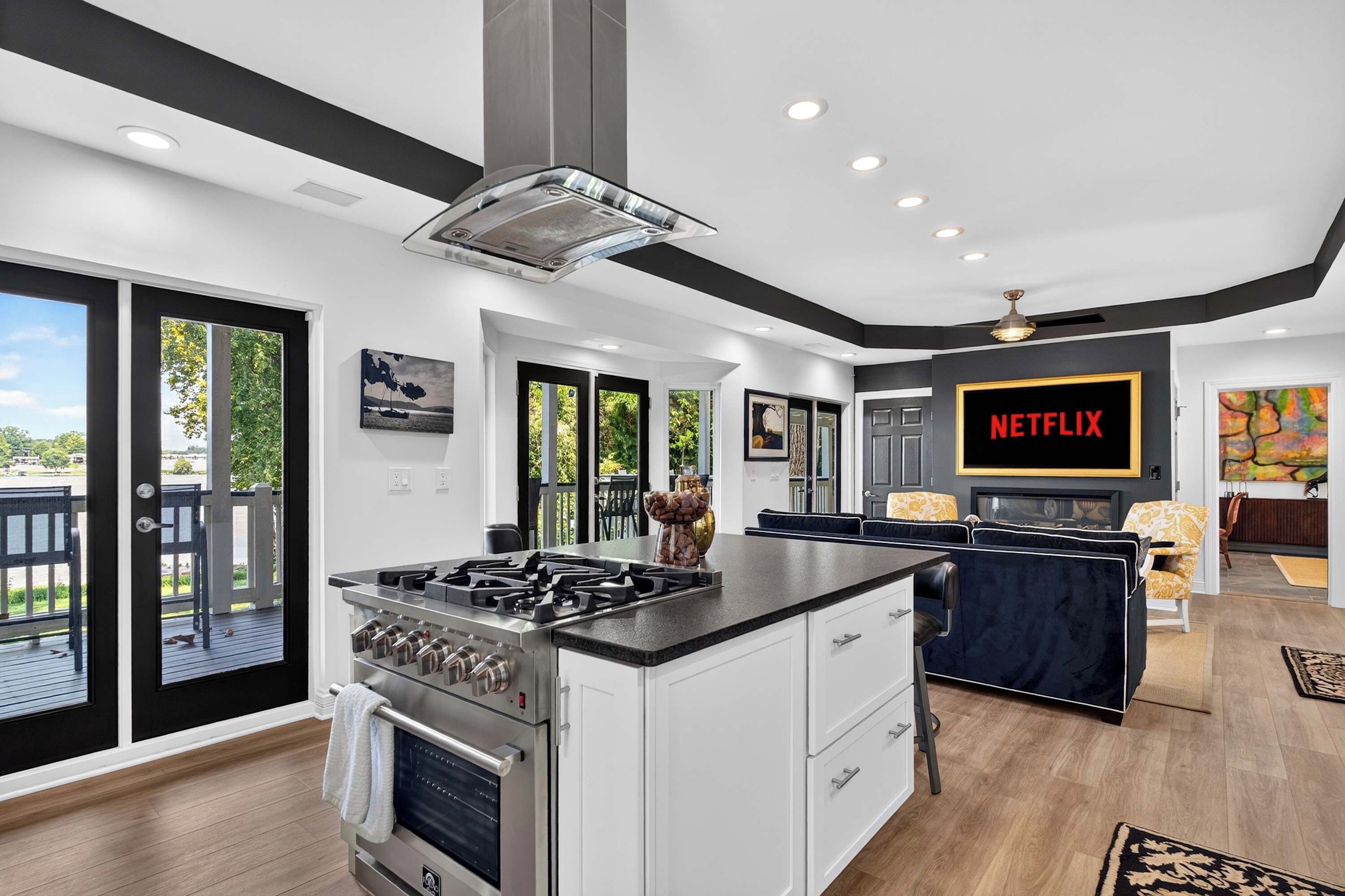 A modern kitchen with a central island, a built-in oven, and a gas stove.